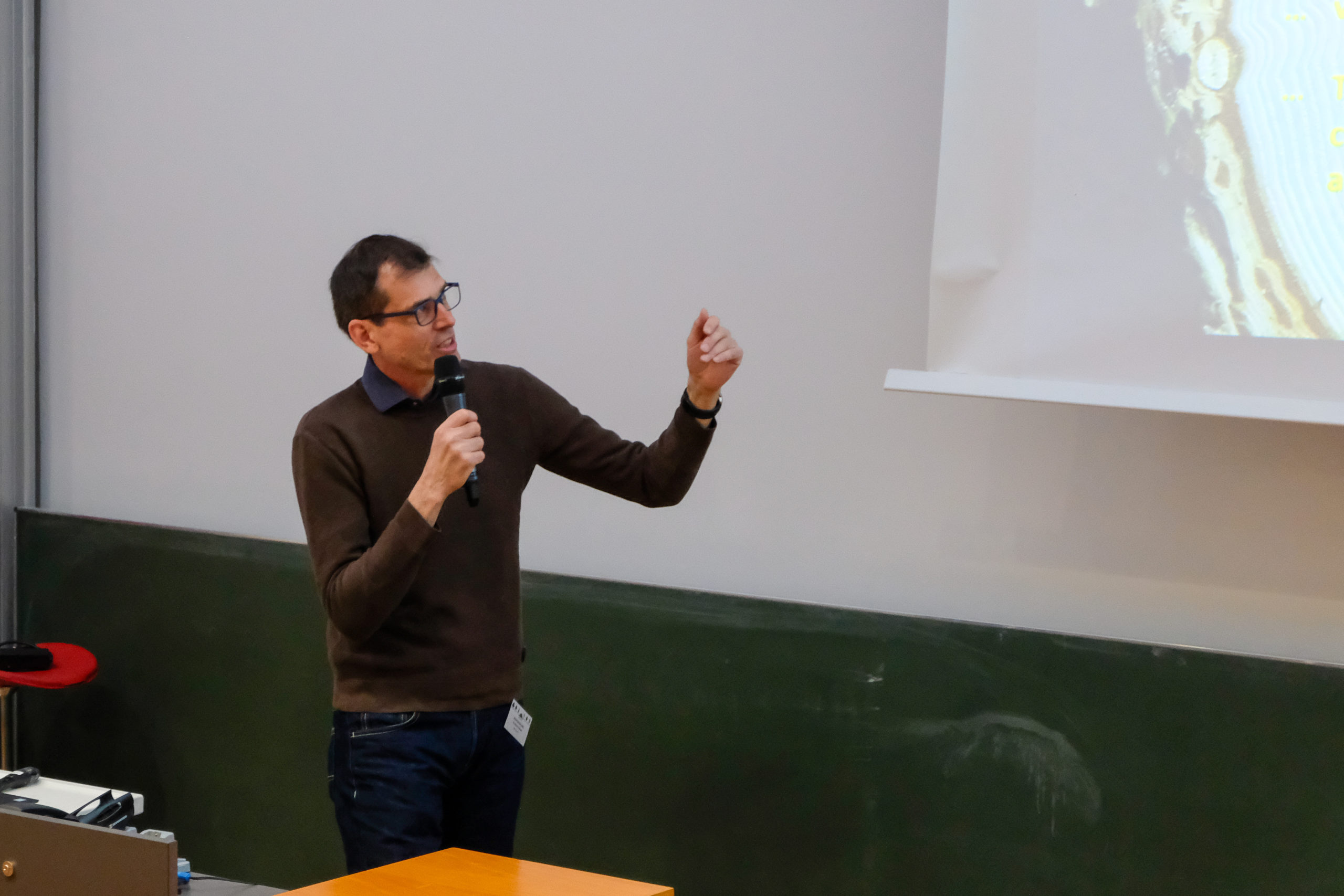 A speaker gestures at the projected slide during SmartForest 2026