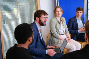 wetransform CEO Thorsten Reitz sits with a laptop on his knees, engaged in discussion with a circle of other participants at SmartForest 2026.