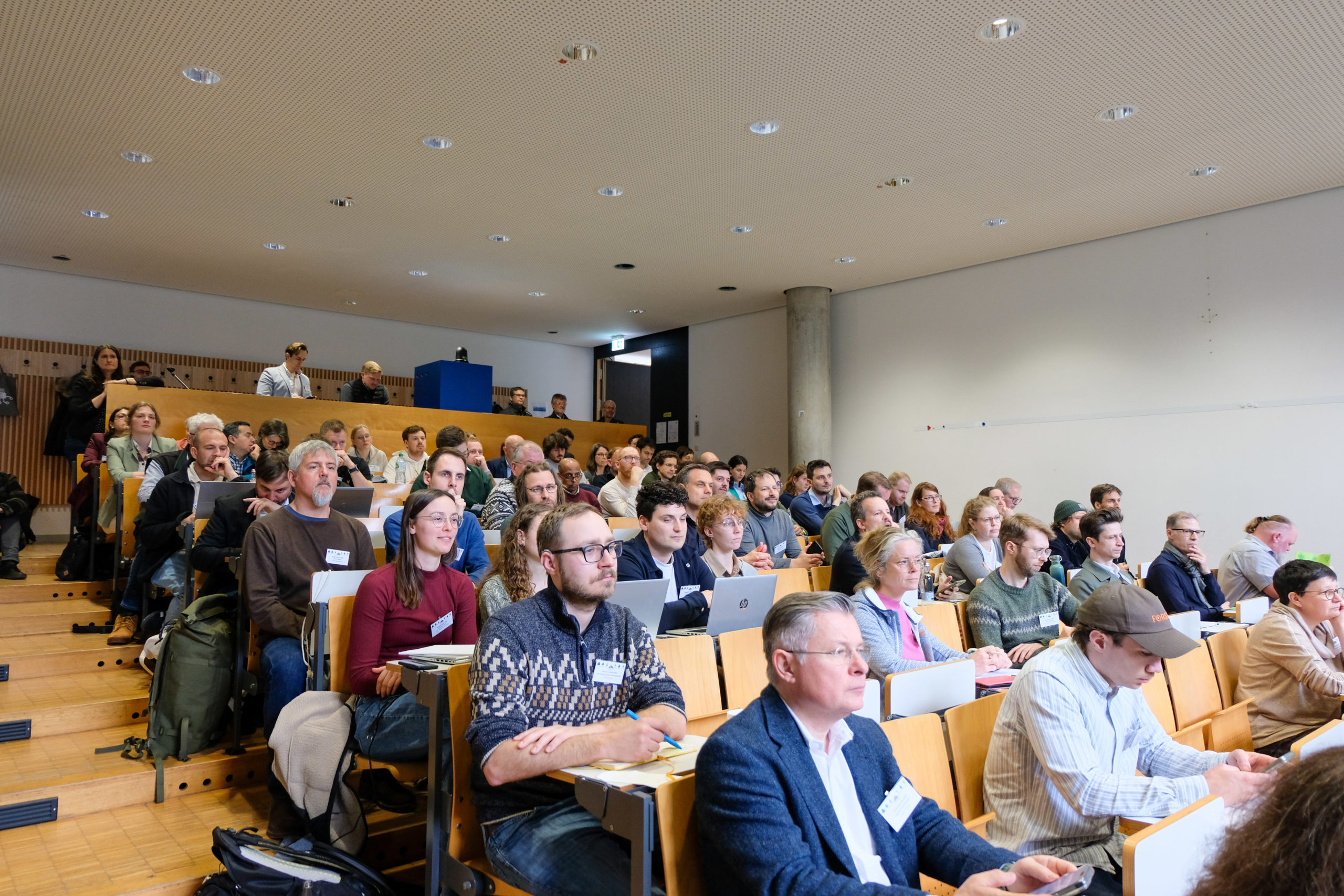 A varied crowd of people fills the auditorium's benches at SmartForest 2026.