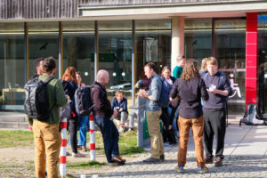 Various participants take advantage of the sun to have chats outside the building during SmartForest 2026