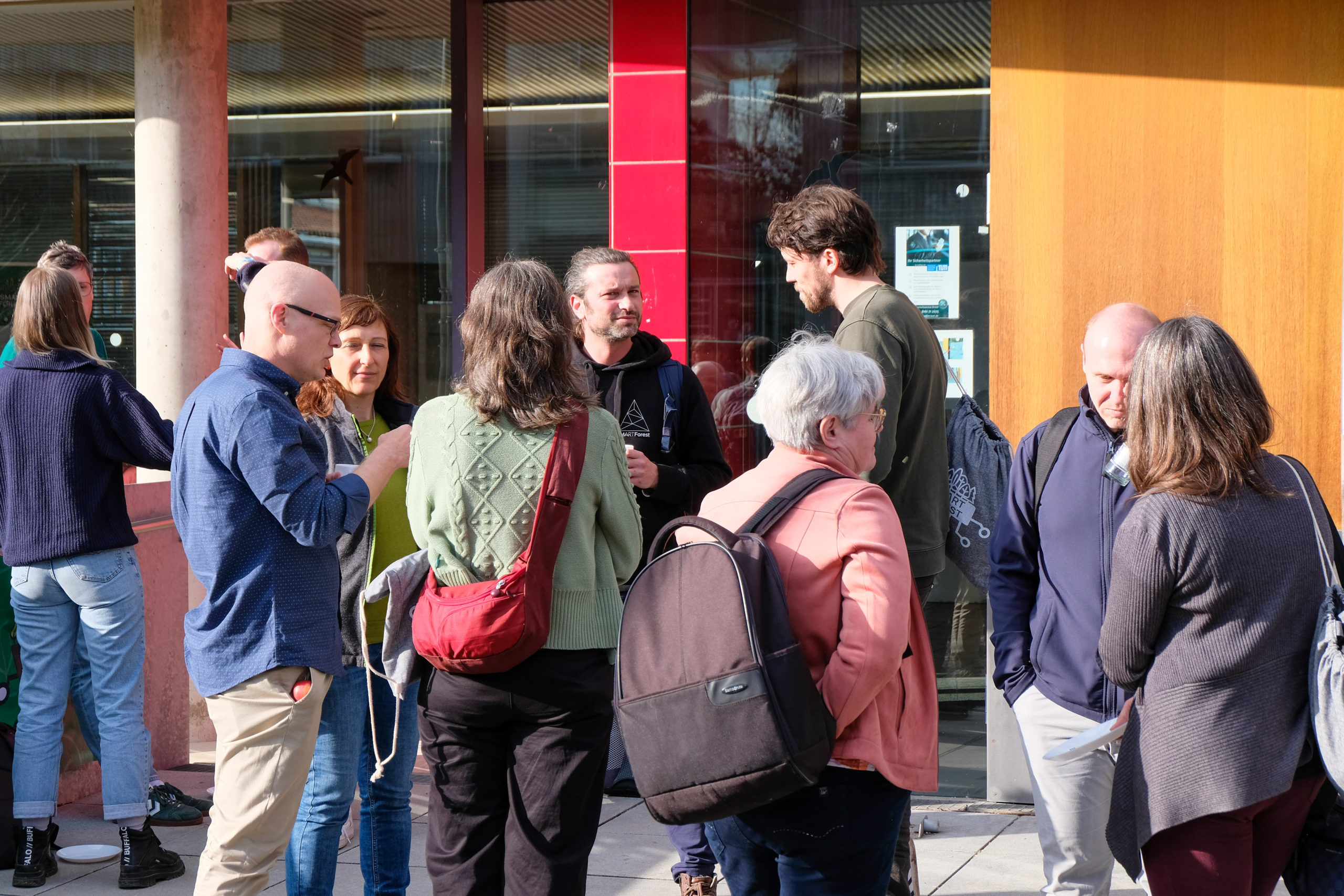 Conference participants engage in discussions outdoors during SmartForest 2026.