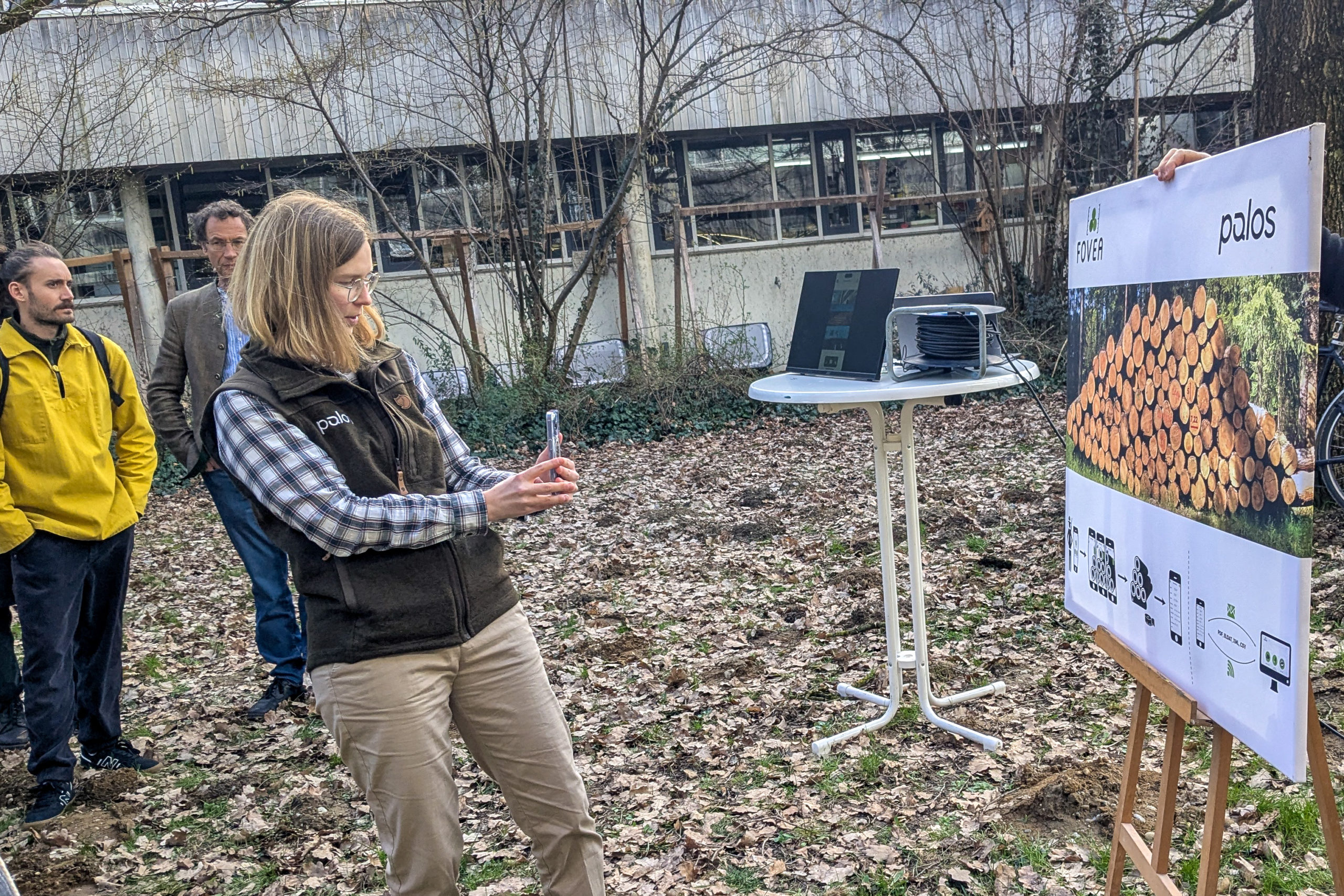 Ina Wilken of palos GmbH demonstrates smartphone-based forestry software during an outdoor session at SmartForest 2026.