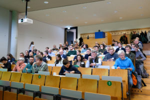 People examine their programme booklets in an auditorium at the SmartForest 2026 conference