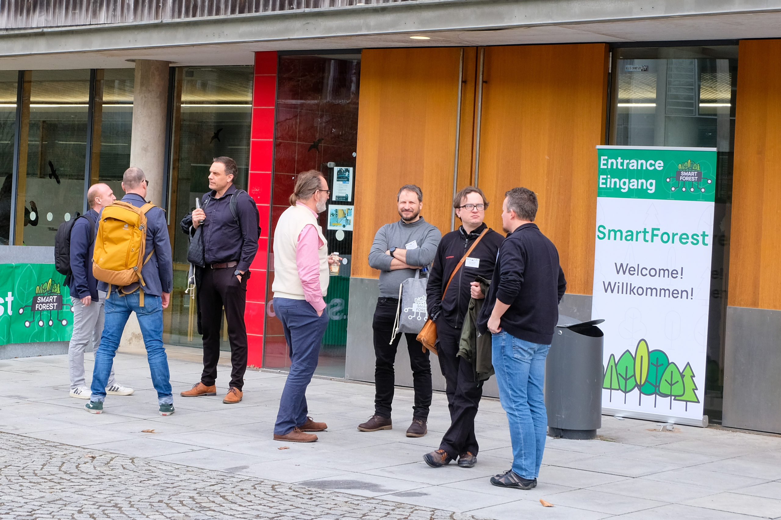 Conference participants chat in front of the entrance at SmartForest 2026