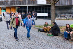 Conference participants walk, sit, and chat outside during SmartForest 2026