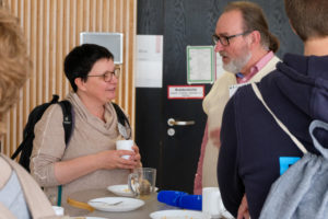 Two SmartForest 2026 conference participants chat over coffee and tea during a break.